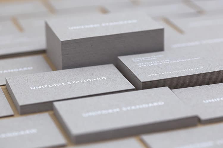 uniform standard business cards white foil stamped recycled greyboard stacks-1 750