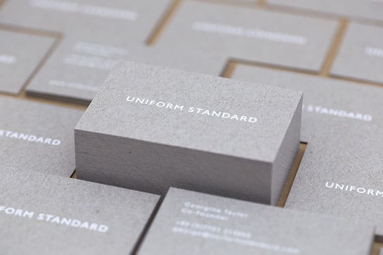 uniform standard business cards white foil stamped recycled greyboard stacks-2 750